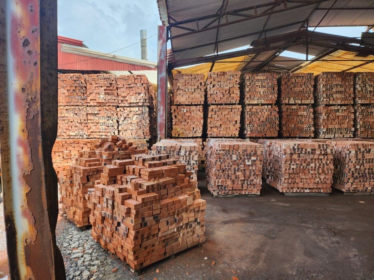 Packaged brick inventory stored across covered production bays.