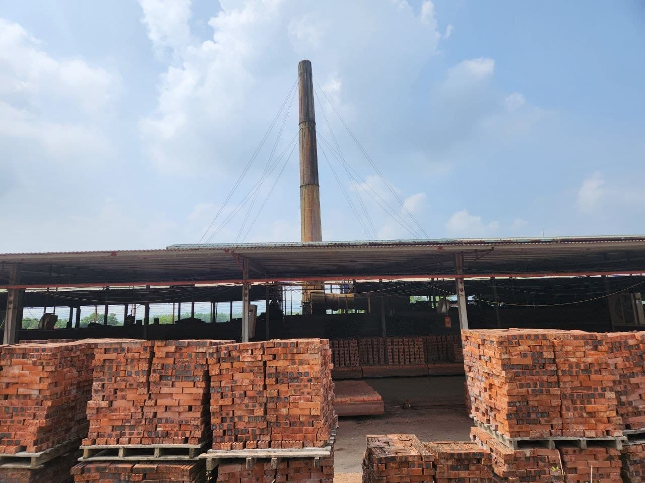 Exterior view of the brick facility, kiln area, and chimney infrastructure.
